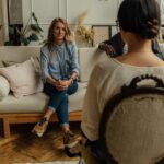 A therapist and client in discussion during a cozy indoor session highlighting mental health.